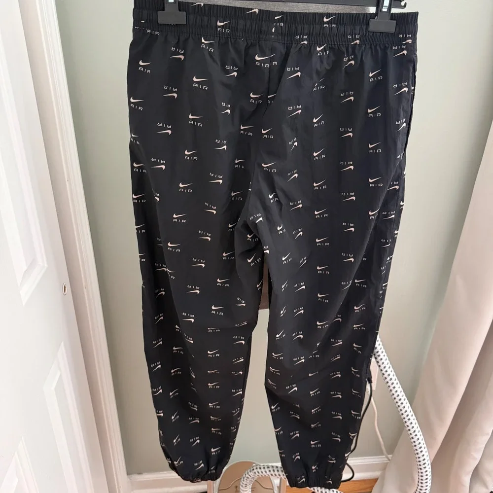 Nike Air Womans Large Woven Jogger Pants Black All Over Swoosh Logo DV8058-010